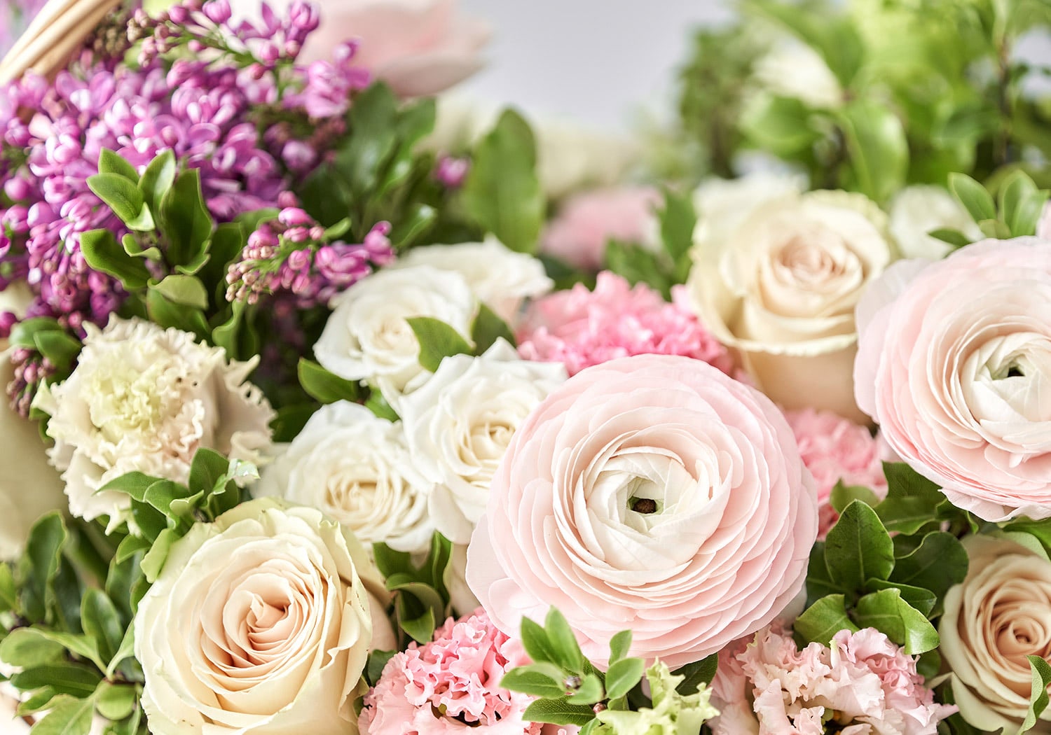 Soft pink and cream roses arranged with greenery, showcasing stunning spring flowers.