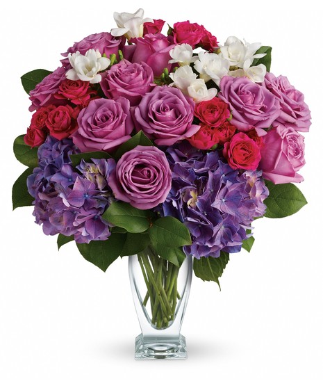 A fanciful combination of succulents, hydrangea and garden roses with a delicate touch of tulips makes this an elegant arrangement.